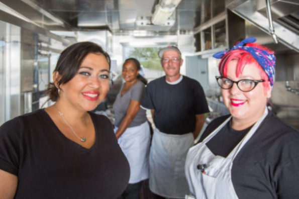 Crew of Four Workers In Food Truck food trucks