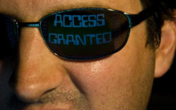 The smiling face of a computer hacker payment card security